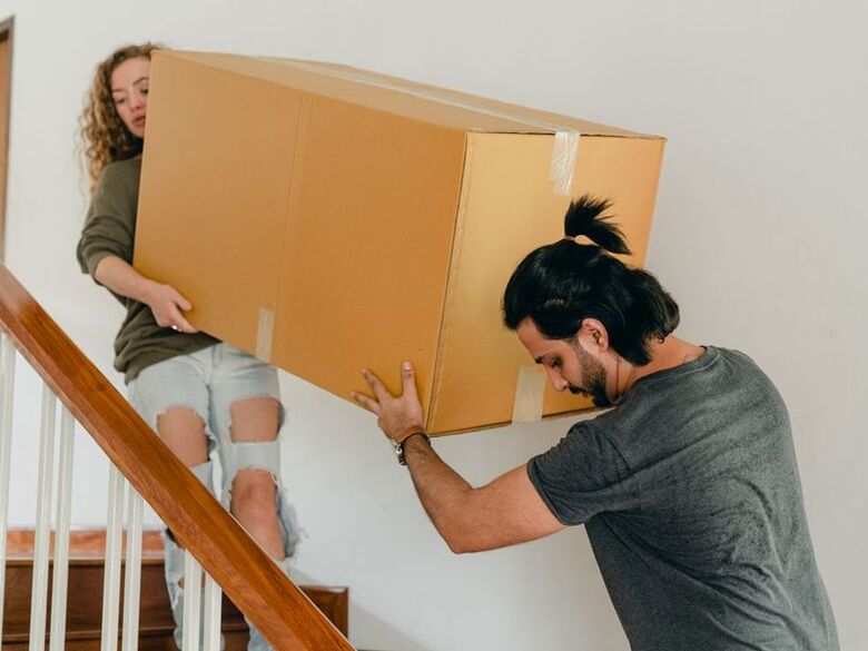 House Moving Houston crew moving boxes into a Houston high-rise apartment lobby